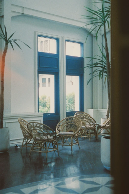 an empty room with chairs and tables next to a large window