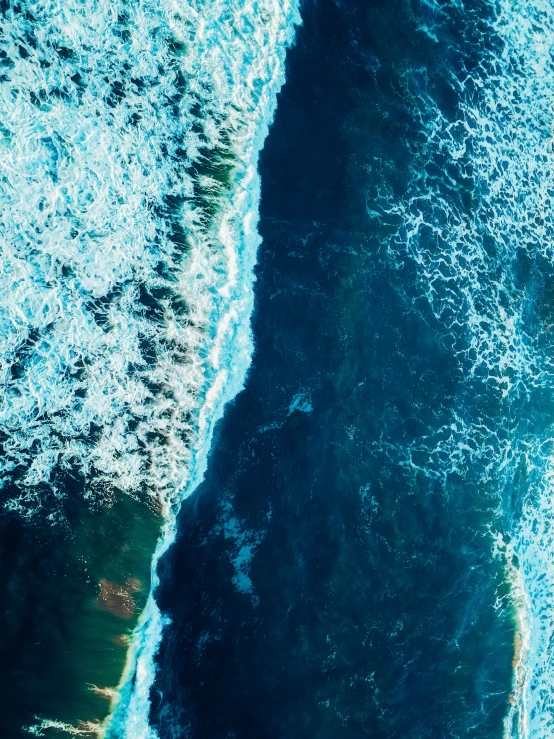 an aerial s of some blue waves in the ocean