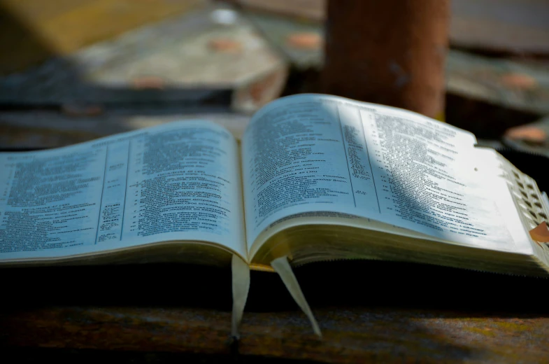 open book with a hole in the middle on a wooden table