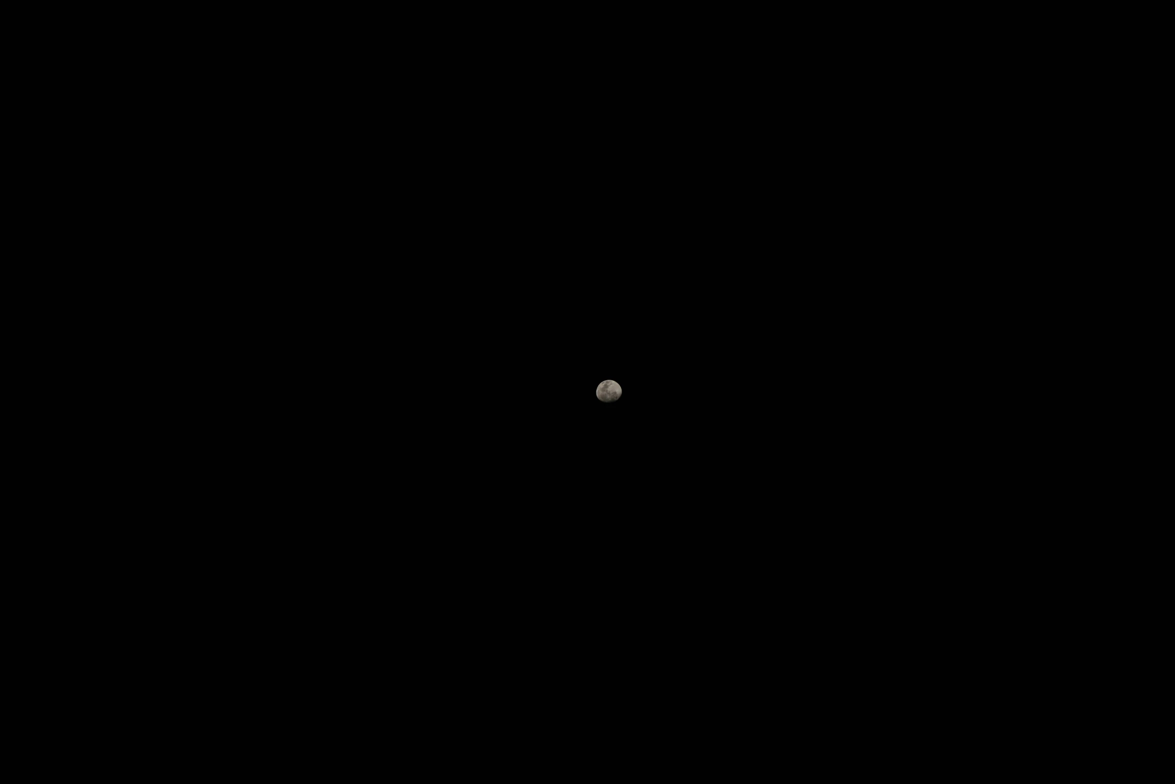 a bright circle with an object near it on a black background