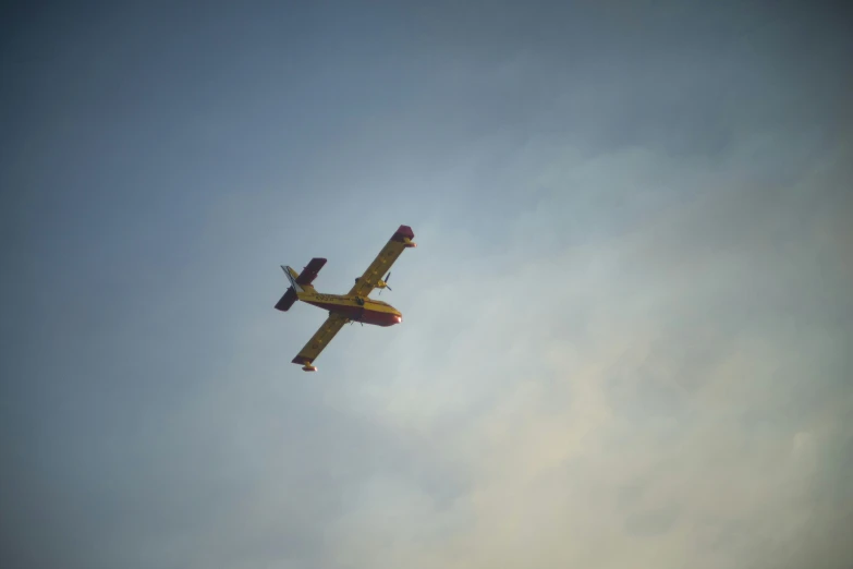 an airplane is soaring overhead during a sunny day