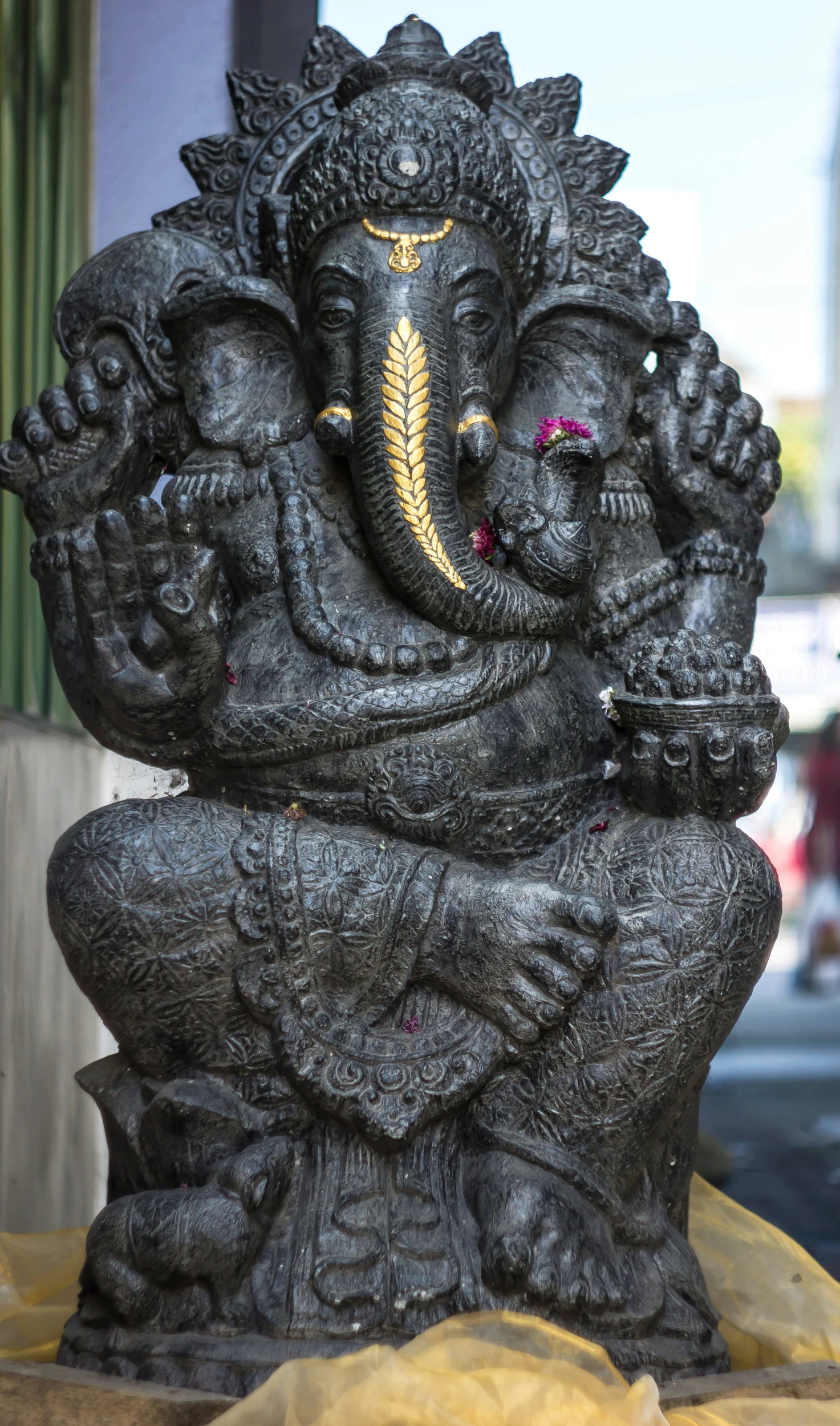 statue of a sitting gan in a street