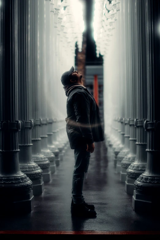 man standing in doorway with a clock in the background