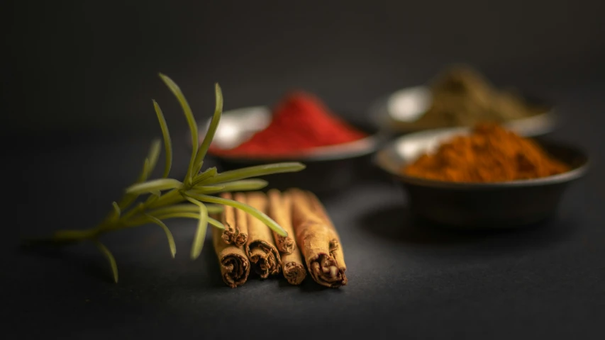 cinnamon sticks and spices sitting on a counter