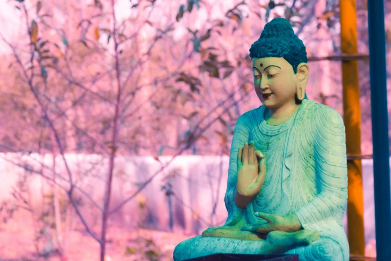 a blue buddha statue sitting on a red table