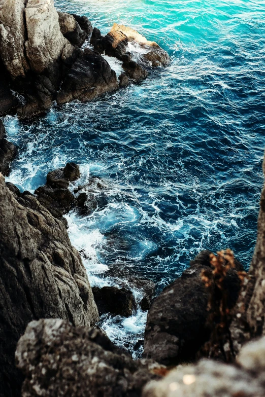 the water is very choppy near the rocks