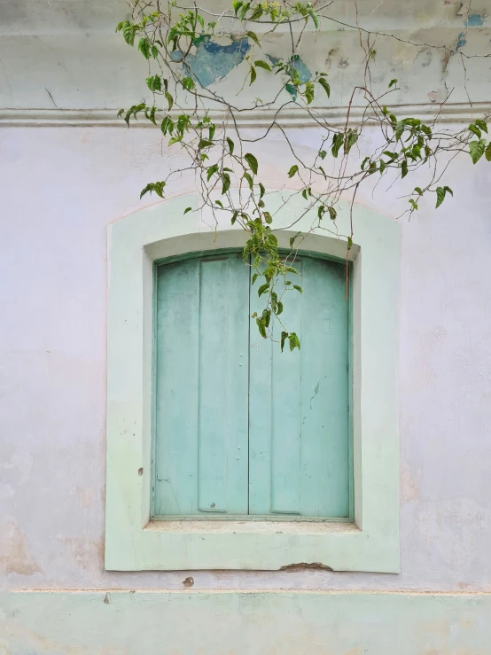 the window frame on the front of a painted building