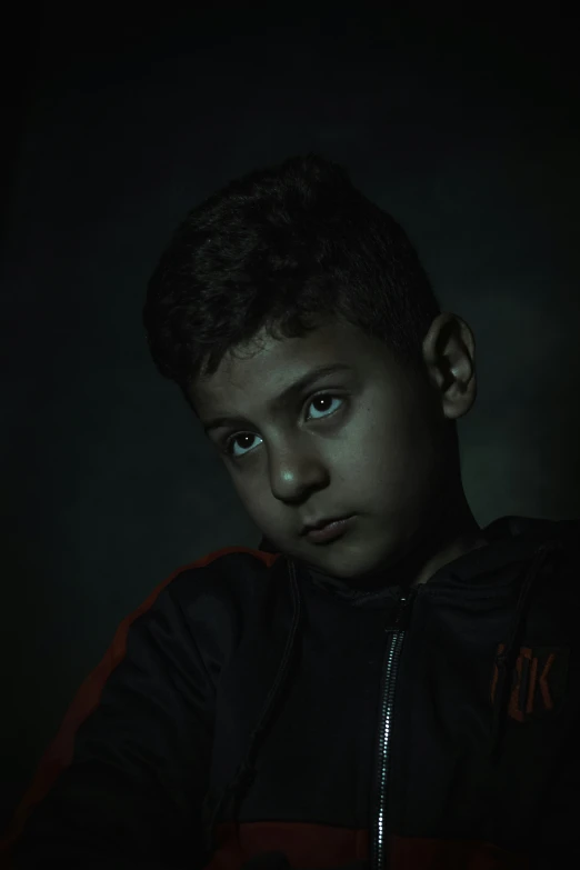 a child with dark lighting in the background