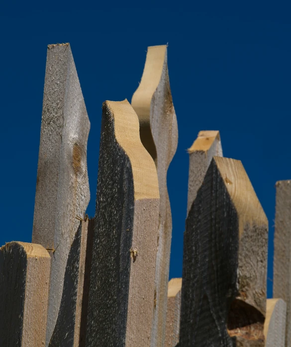 a wooden fence with a sky in the background