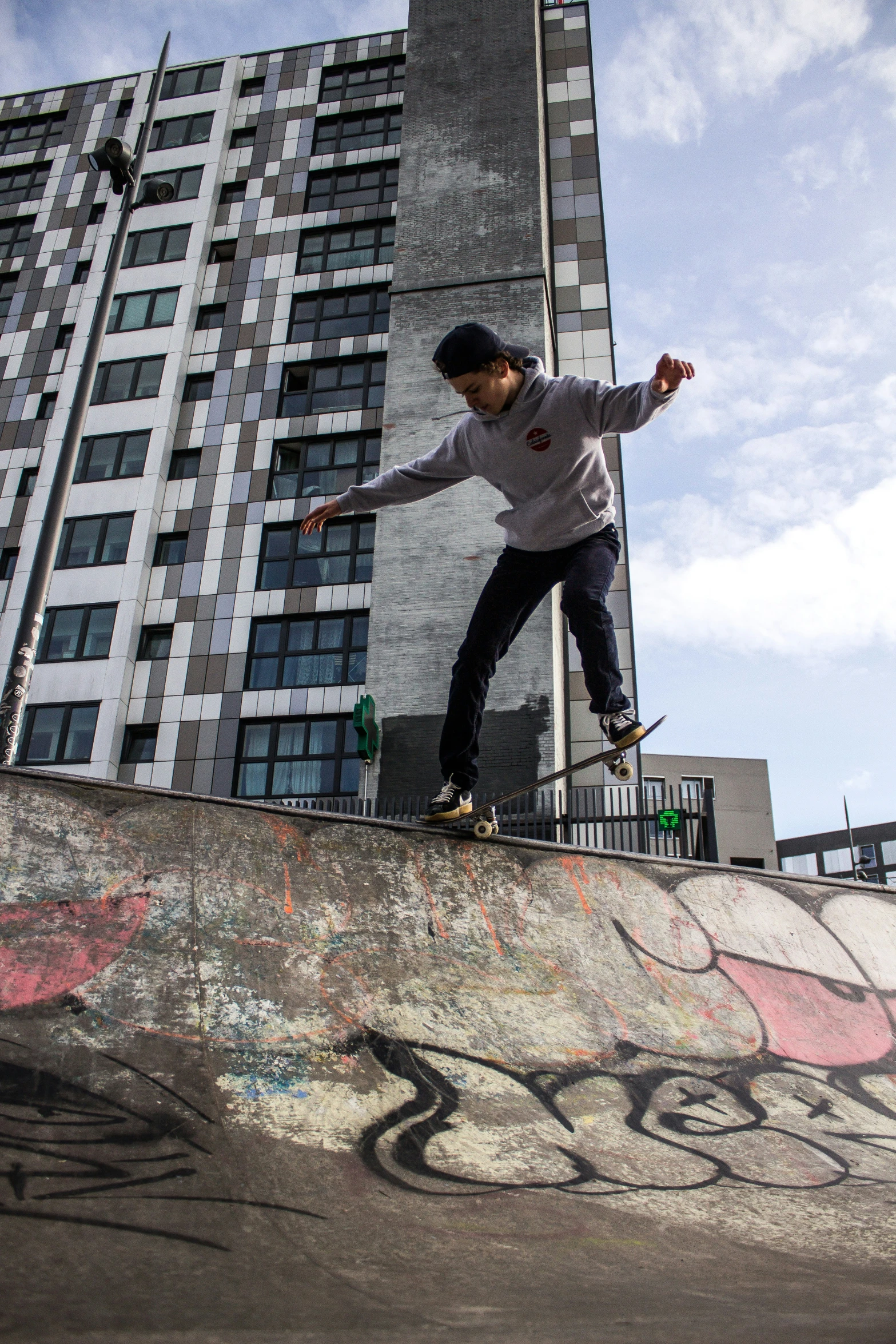 a boy is on top of a half pipe skateboard