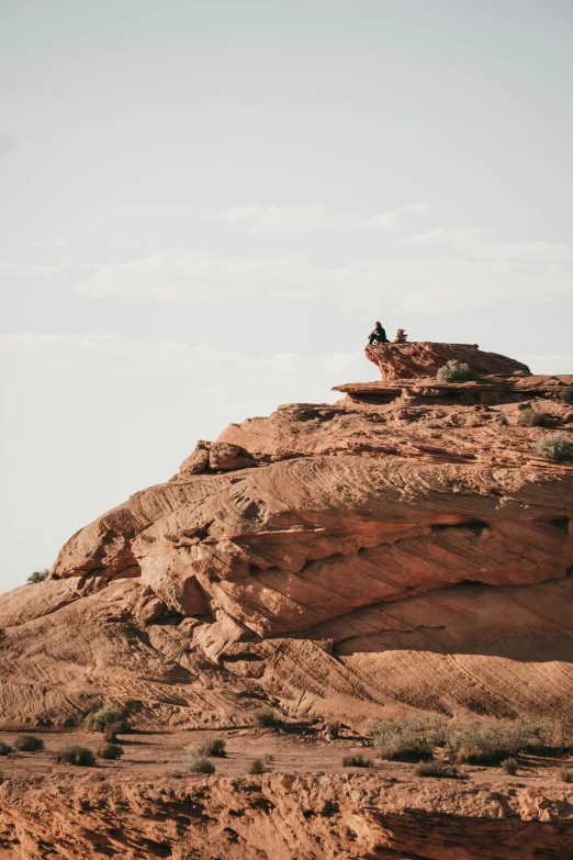 people on an outcropping high up in the sky