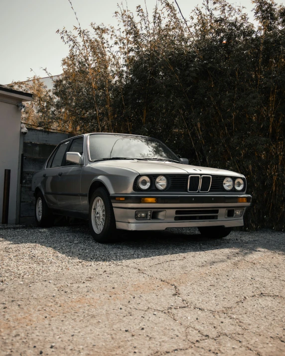 a car is parked near some green bushes