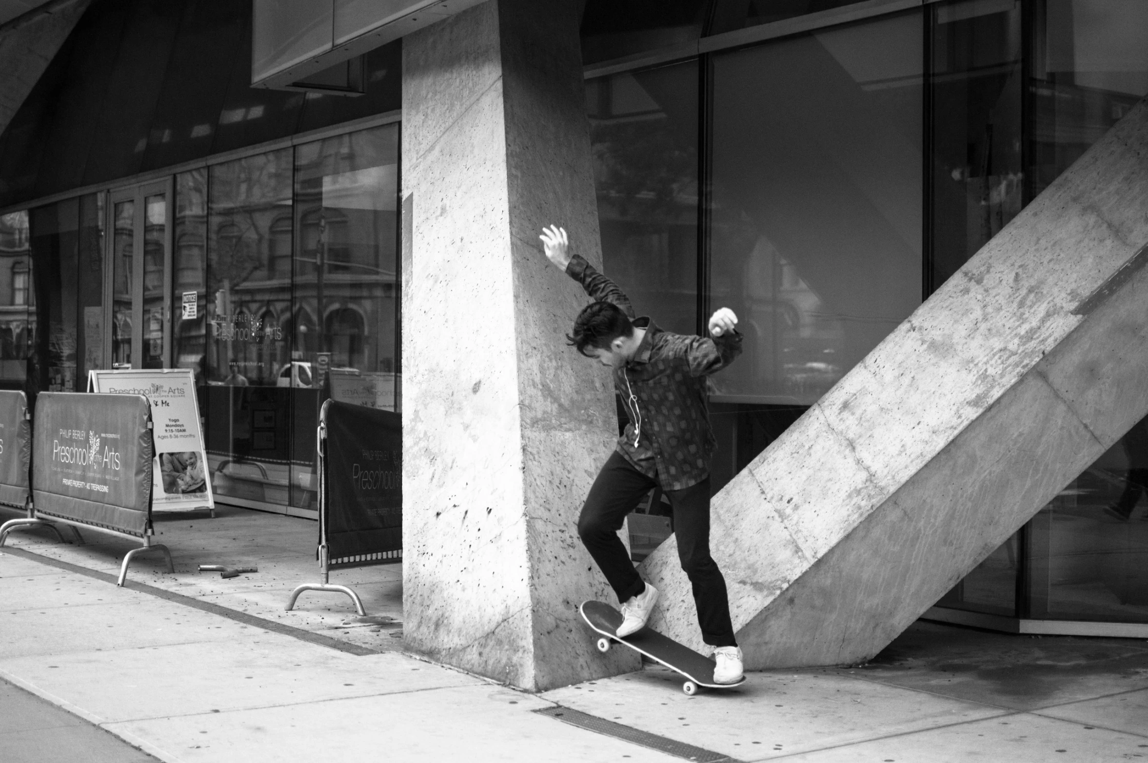 a person riding a skateboard next to a building