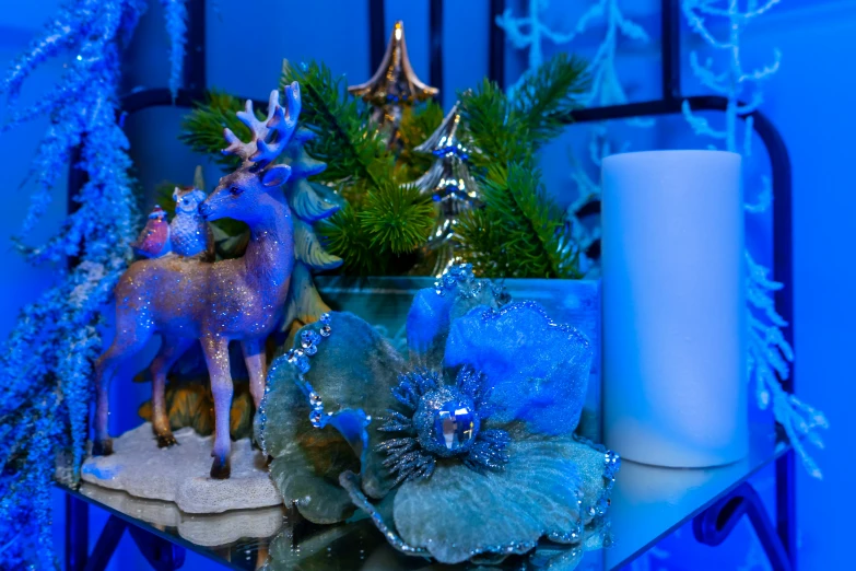 a table with a lighted decoration, candle and blue decoration