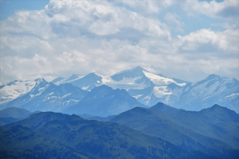 mountains that are covered in snow on a cloudy day