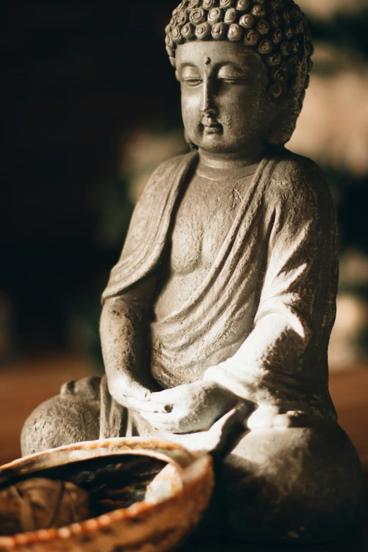 a buddha statue sitting in the middle of a table