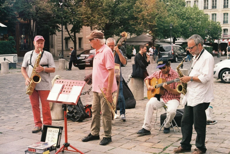 there are many musicians outside together in this city square