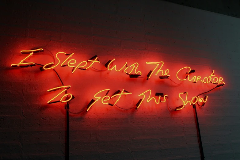 a neon sign with words on it on the wall