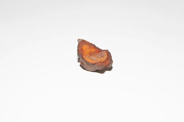 a small orange object sitting on top of a white counter