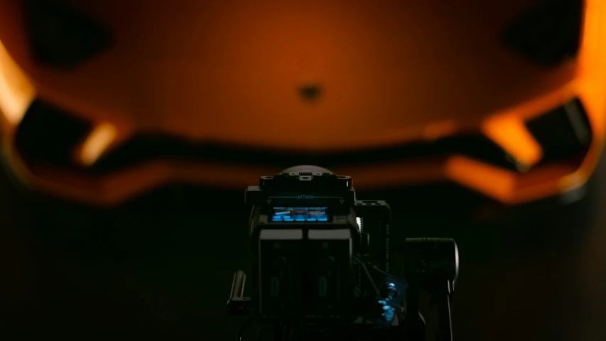 an orange helmet with no face and a video camera
