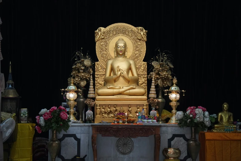 a small shrine with a golden buddha statue