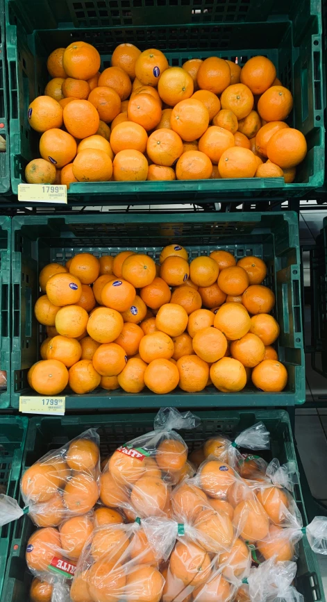 oranges in a grocery store, with plastic bags on them