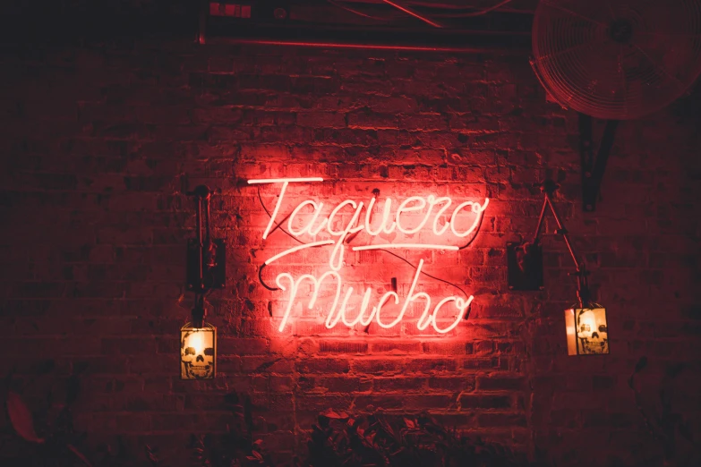 a red neon sign on the side of a building