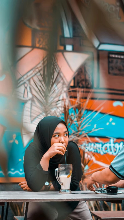 a woman sitting at a table and eating