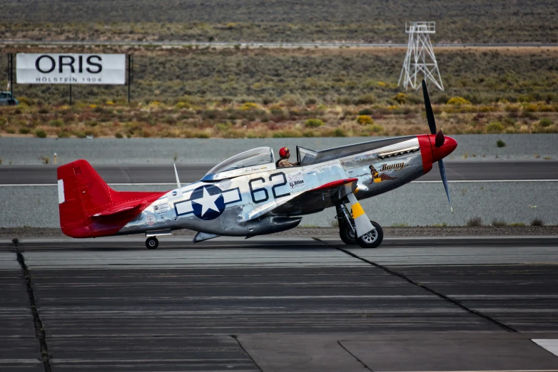 a small airplane with a man in the cockpit on the runway