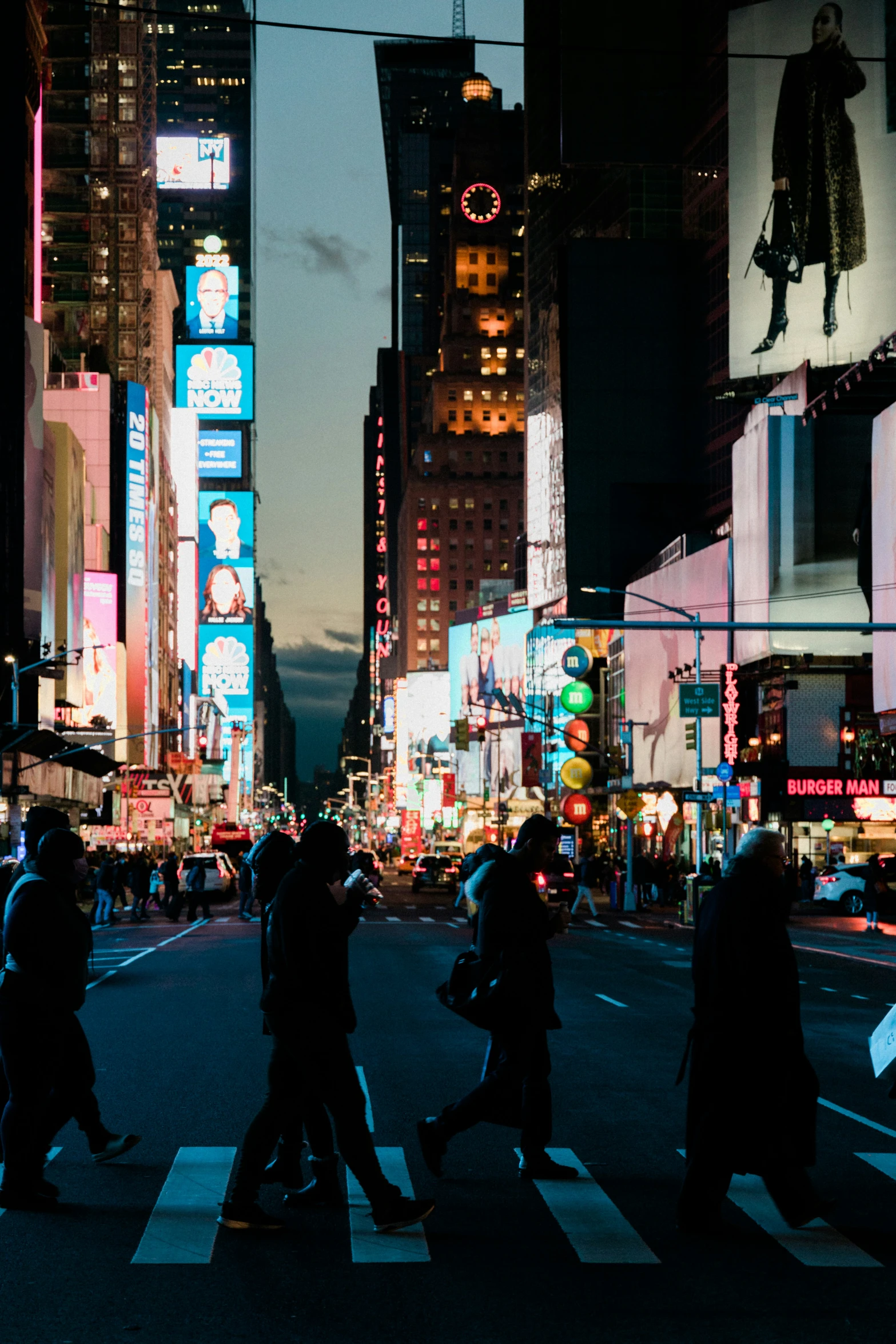 a group of people crossing a street in the city