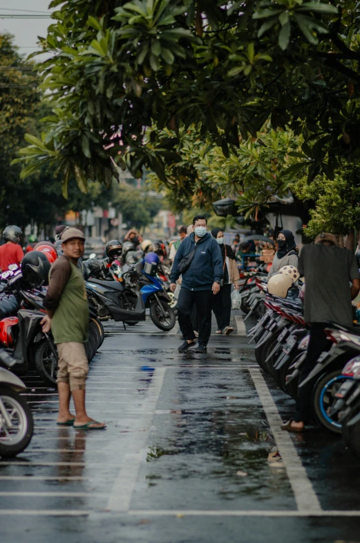 motorcycles parked along a street in the rain