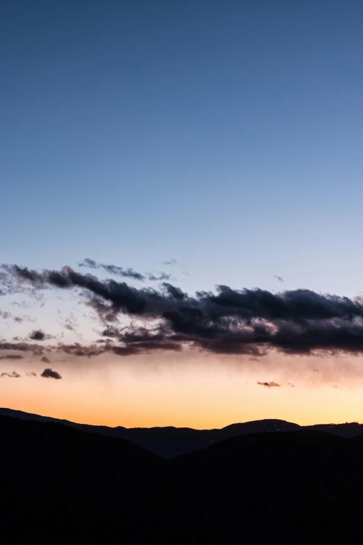 airplane with no flaps flying in front of sunset