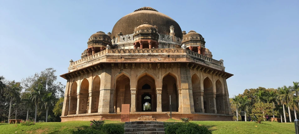 an ornate old domed building sitting on a hill