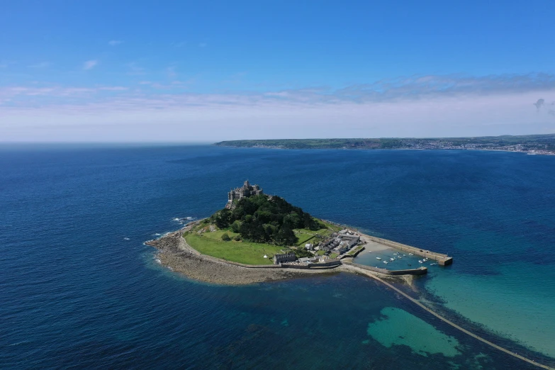 an island surrounded by blue water with an island in the middle of it