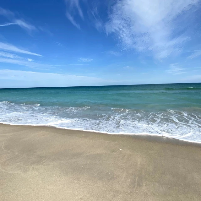 the blue ocean water on a sandy beach