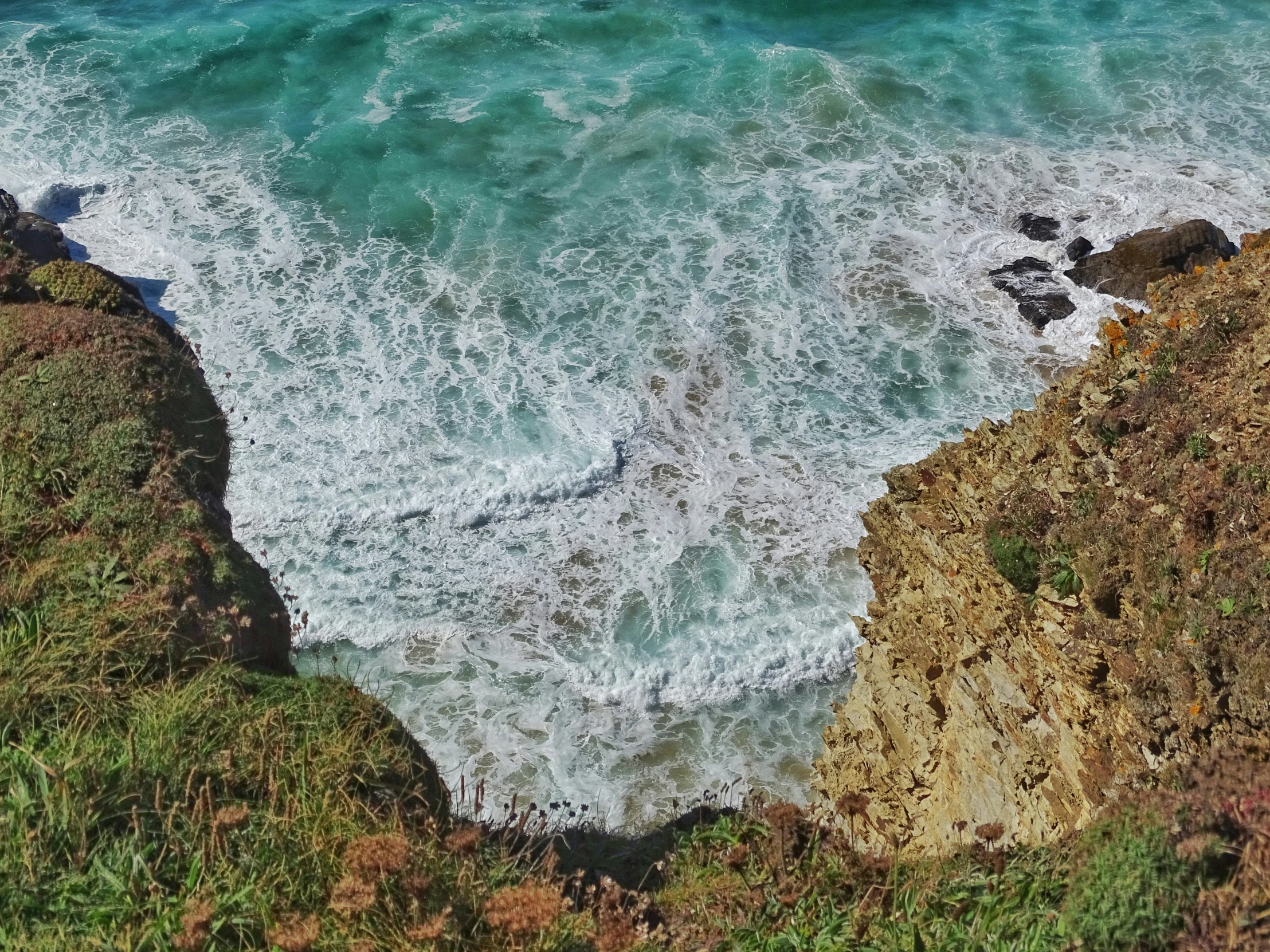 a view of the sea from above a cliff