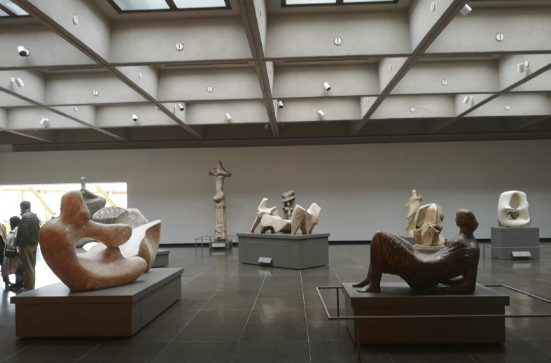 many sculptures sitting in a museum on display