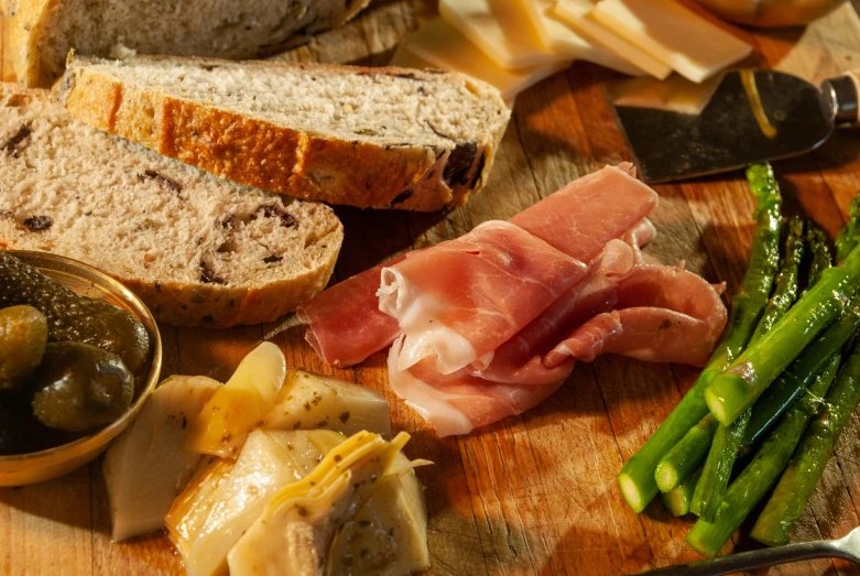 this is a plate of sliced bread, olives, bread, and other meat