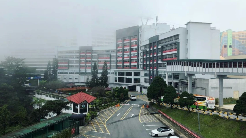 a foggy city street surrounded by buildings