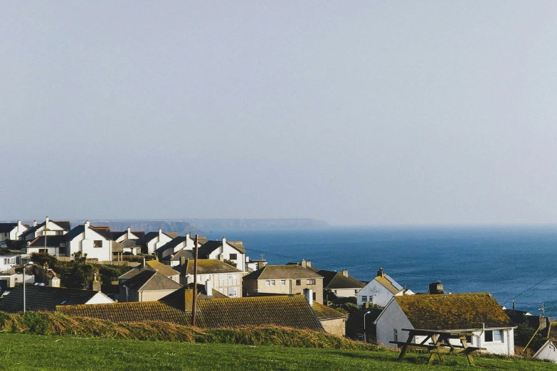 there is a small group of houses along the edge of the ocean