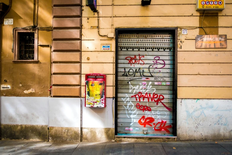 an open garage door covered in graffiti on a city street