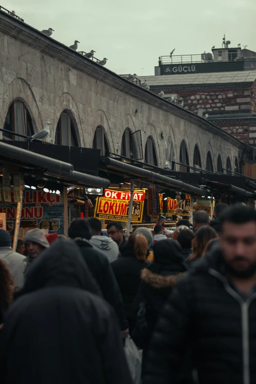 an outdoor market with several people standing around