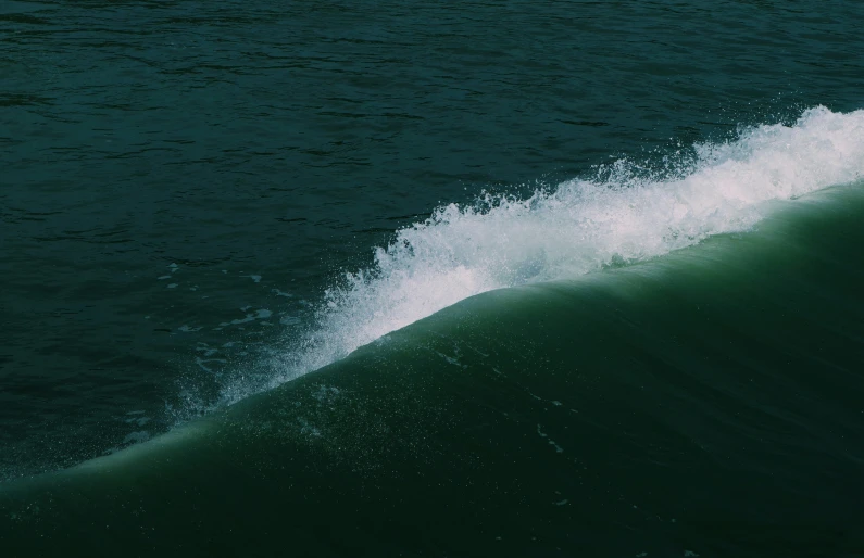 a person riding a surfboard on top of a wave