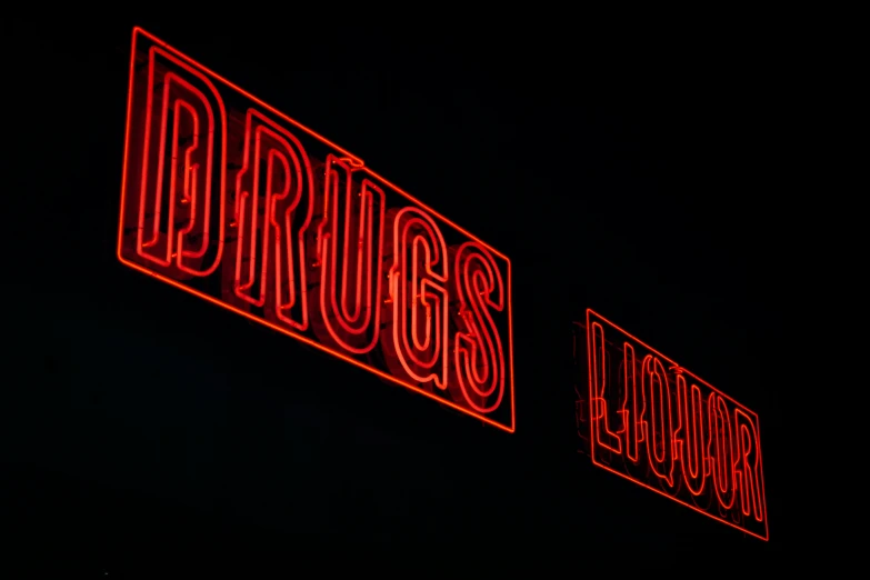 two neon signs are lit up with red light