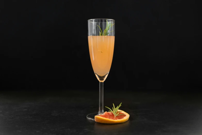 a glass filled with some champagne and fruit