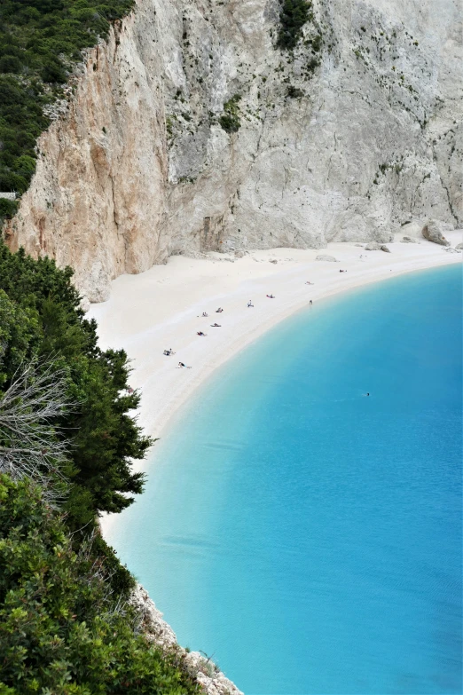 a beach in the mountains with a blue water