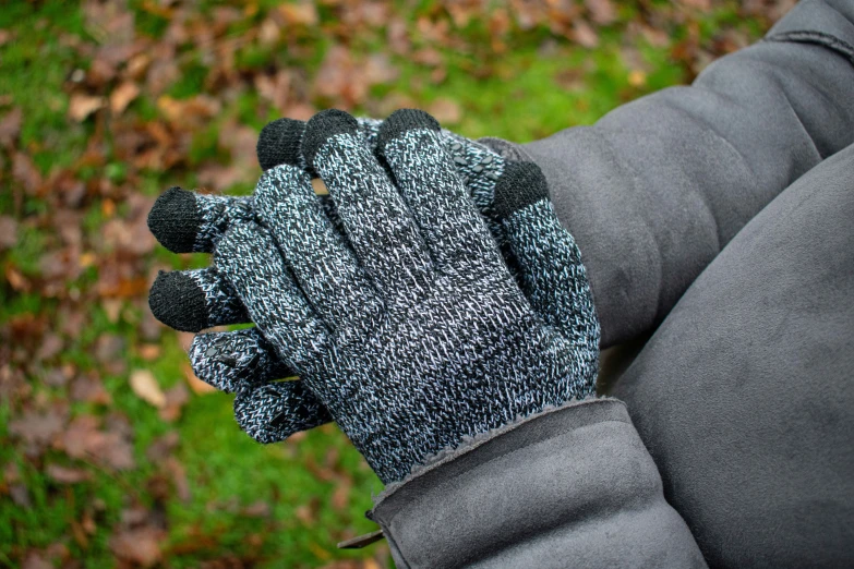 person wearing gloves holding up soing in their hands
