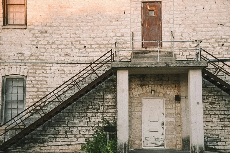 an old building with a stairway and a door