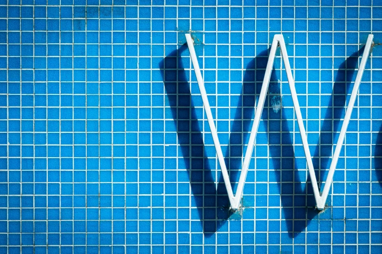 a tile wall with a w and m made of three diagonals