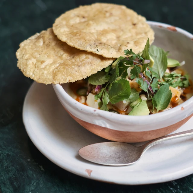 a bowl filled with soup and pita chips